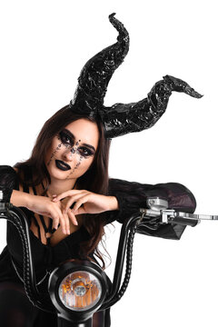 Woman dressed for Halloween with motorcycle on white background