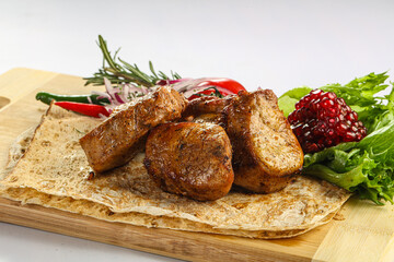 Pork tenderlion kebab over board