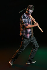 Obraz premium Scary zombie with pick-axe on dark background