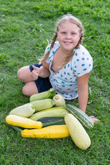 A girl with vegetables grown in the garden.
