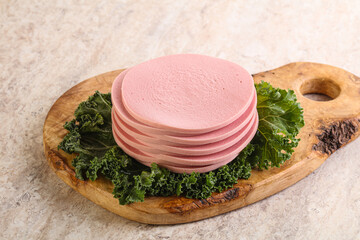 Slices pork sausage over board