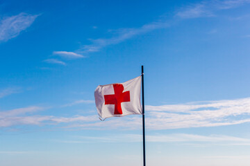 white flag with red cross