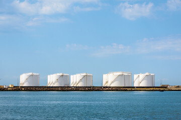 White storage tanks in a marine oil terminal