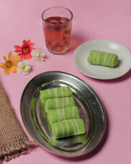 Rolled omelette filled with grated coconut. Cake with a soft texture and sweet taste. Market snacks. Indonesian and Malaysian cakes. Roll omelet mockup. Focus blur.