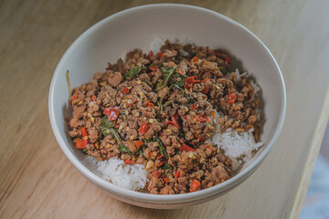 Stir fried pork with basil on topped boiled rice is popular thai style street food.