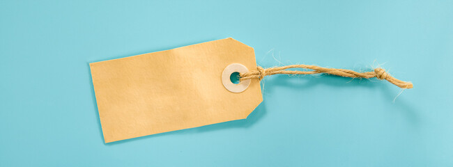 brown tag or price label over blue background. promo, discount or sale concept, space for text, promo or ad. 