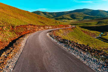 Empty winding downhill road in beautiful mountain landscape of Zlatibor, Serbia
