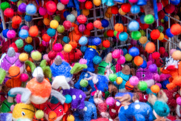Colorful peluches and toys in a shop, background abstract.