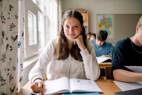 Portrait of teenage girl student in high school classroom