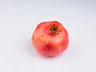 Close-Up Of Pomegranate Against White Background