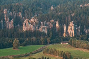 Obraz premium Adrspach rocks at sunset. Aerial top down view of trail path in rock formations, cliffs and trees of Adrspach Teplice rocks national park. Adrspach, Bohemia, Czech Republic, Czech mountains landscape.