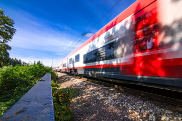 A speeding train on railroad tracks, image blurred by speed. Vivid picture.