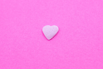 Pink heart on pink background. Saint Valentine's day concept. Love and romantic photo. Postcard for holiday. Beautiful warm wallpaper with love. Soft focus. Copy space.