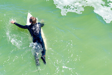 ST AUGUSTINE, FL - FEBRUARY 16, 2016: Surfer goes against the waves.