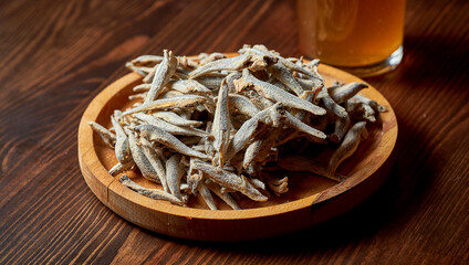 A classic beer snack - dried and salted anchovy fish on a wooden stand. Food pub