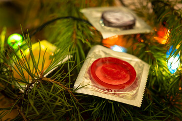 Colorful condoms on Christmas tree as a decoration for the holiday. sex and love in the new year...