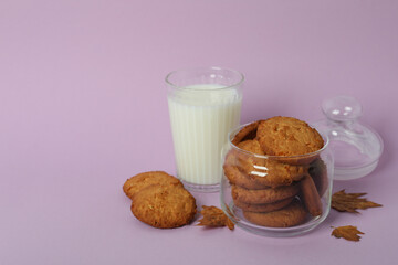 Concept of tasty food with pumpkin cookies on violet background