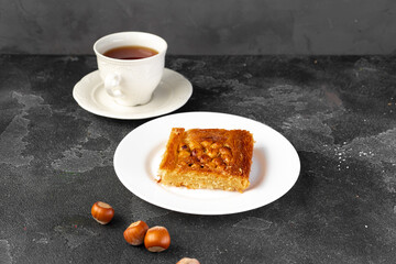Turkish dessert baklava with nuts on black background