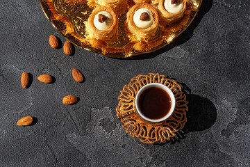 Obraz na płótnie Canvas Turkish dessert baklava with a cup of coffee on black background