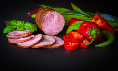 meat  sausage and vegetables on dark background