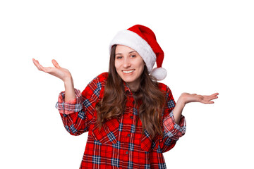 Young woman wearing Christmas hat is shrugging over white background.