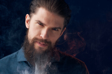 handsome man in a black shirt smoke clouds isolated background