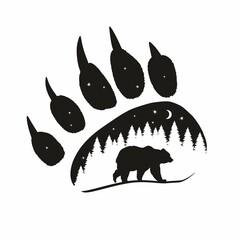 The silhouette of a bear against the background of the forest at night in the imprint of a bear's paw © Abundzu