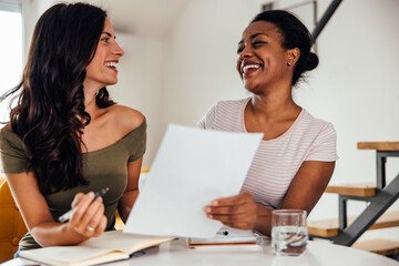 Adult women, sharing her timetable with her friend.