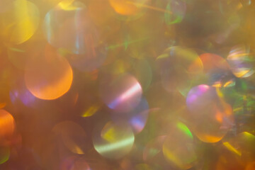 Abstract festive background made of multicolored bokeh. Unusual sparkling iridescent pearls with...
