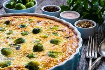 Gartenposter Millet quiche with brussels sprouts and ricotta on wooden table  © Jacek Chabraszewski