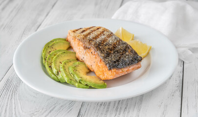 Fried salmon with avocado slices