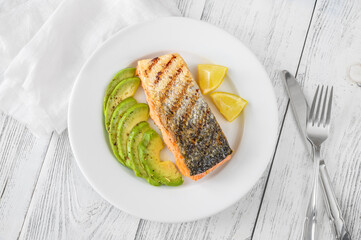 Fried salmon with avocado slices