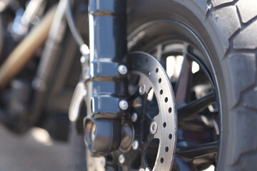 Closeup of metal brake disc on motorcycle wheel