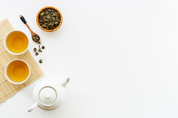 Asian food and drink background white teapot and black tea in two cups