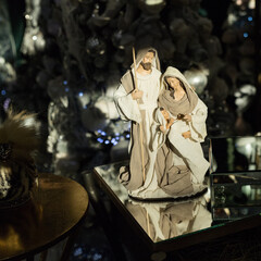 Close up of holidays location with religious figurine on a mirror table