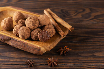 Vegan truffles with spices on a wooden table. Sugar, gluten and lactose free, healthy food.