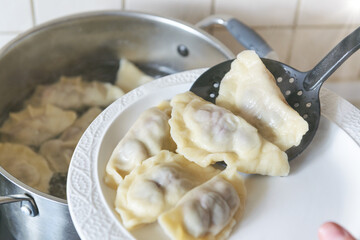 Cooking fresh dumplings with cherry filling