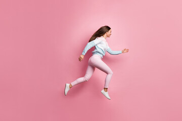 Fototapeta na wymiar Full length body size side profile photo of cheerful girl jumping running fast traveler isolated on pastel pink color background