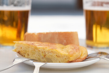 Piece of Spanish omelette and beers.