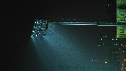 Rack focus of stadium lights in front of a dark blue sky. Light Stadium at night, baseball and hockey. There is a rain or snow. military security lighting towers, patrol in prison. vertical video, - Powered by Adobe