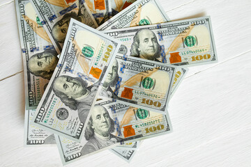 Top view flat lay of cash money american hundred dollar bills on white wooden background, Savings...