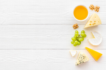 Set of different types of cheese with grapes. Dairy products flat lay
