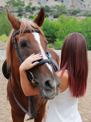 Obraz premium young girl hugs brown horse 