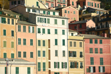 Fototapeta na wymiar Camogli is beautiful with the incredible colors of the ancient and tall houses that are reflected in the Ligurian Sea. Beauty and colors, sun and sea on the Mediterranean