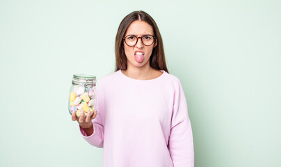 young pretty woman feeling disgusted and irritated and tongue out. jelly candies concept