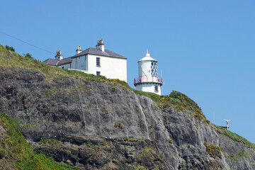 Fototapeta na wymiar Blackhead Lighthouse located at clifftop near Whitehead, County Antrim, Northern Ireland