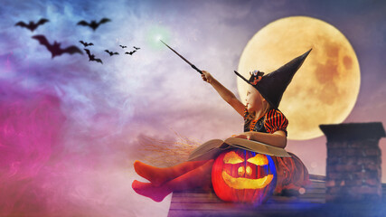 little witch outdoors with the magic wand - helloween concept