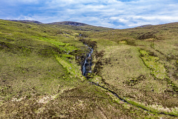 Obraz premium Aerial view of a waterfall in the mountains near Crolly in County Donegal - Ireland