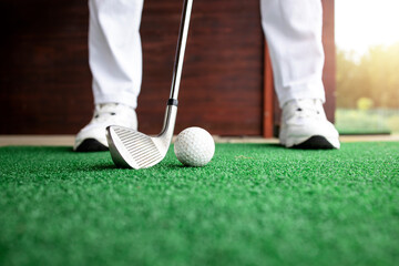 Golfer preparing to hit the ball at golf course. - Powered by Adobe
