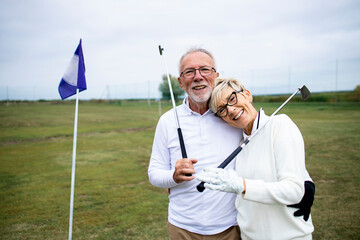 Portrait of senior people or golfers enjoying their retirement on golf course.